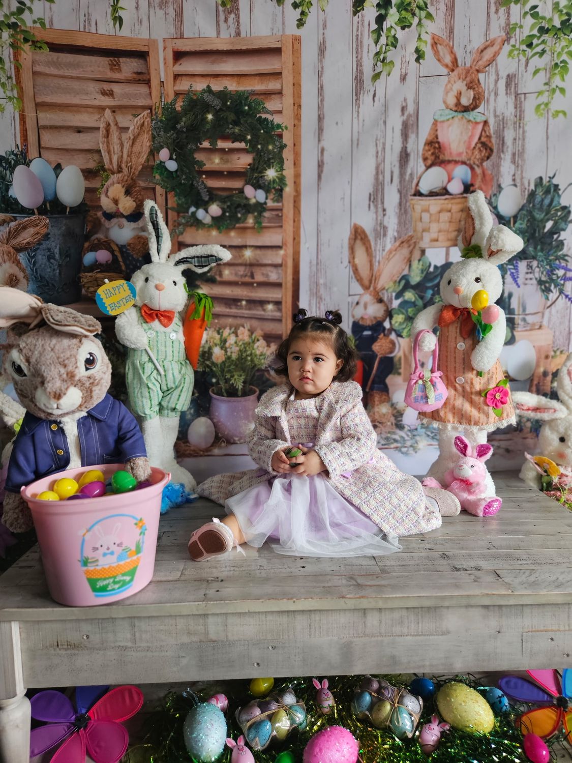 Child in a custom Easter photo set with bunnies and eggs