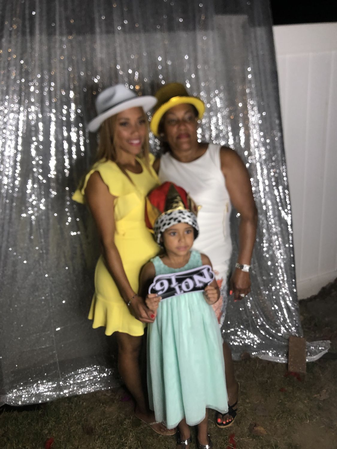 Three guests in front of a silver sequin backdrop