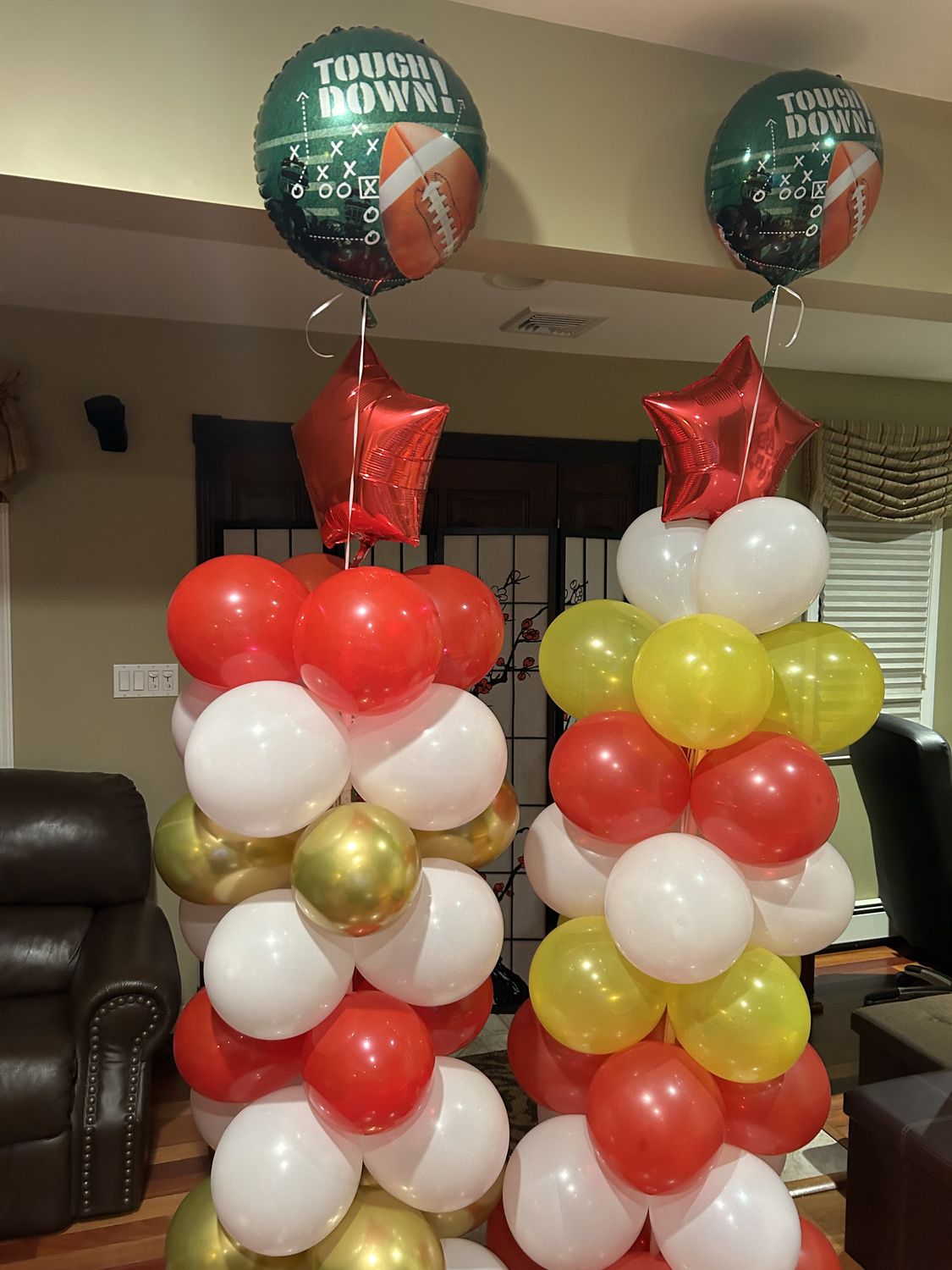 Red, white and gold balloon columns with football balloons