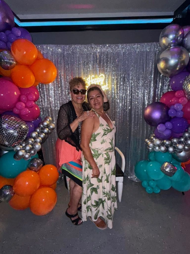 Guests in front of a custom balloon garland