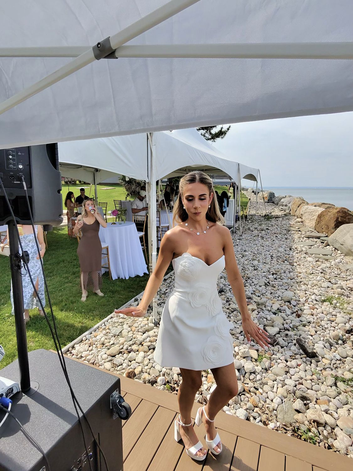 Bride in a white dress at a waterfront celebration