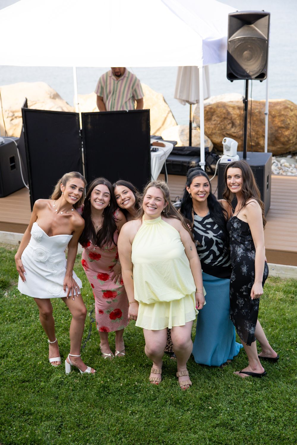 Friends posing together in front of the DJ booth
