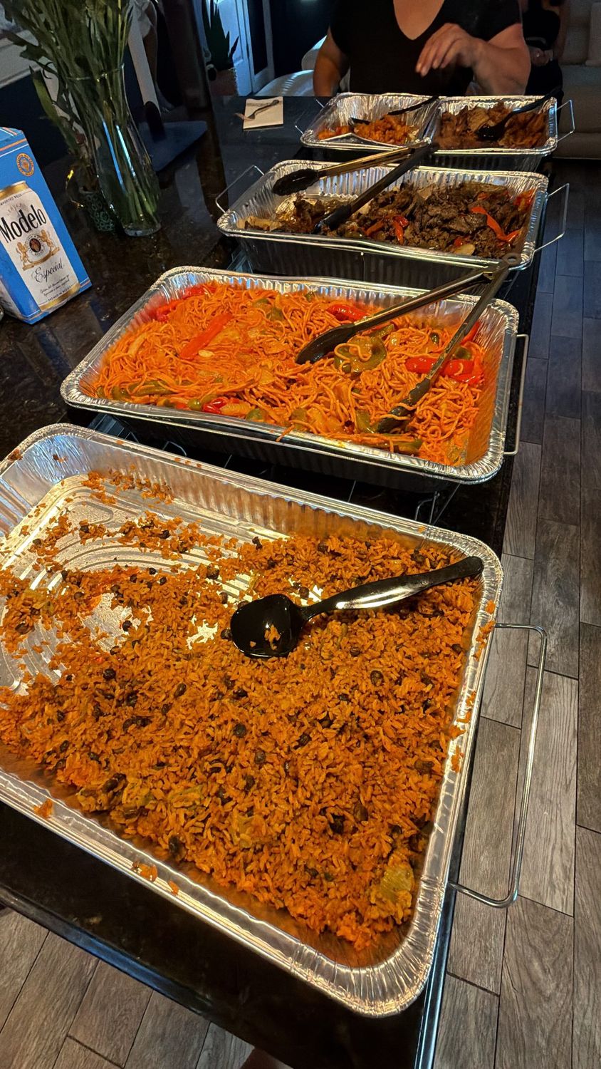 Catering trays of rice and entrees on a buffet table
