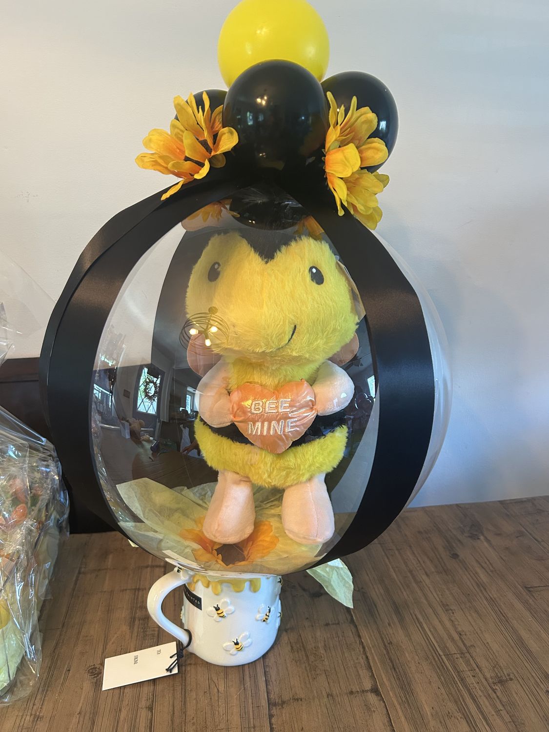 Bubble balloon centerpiece with a plush bee and sunflowers