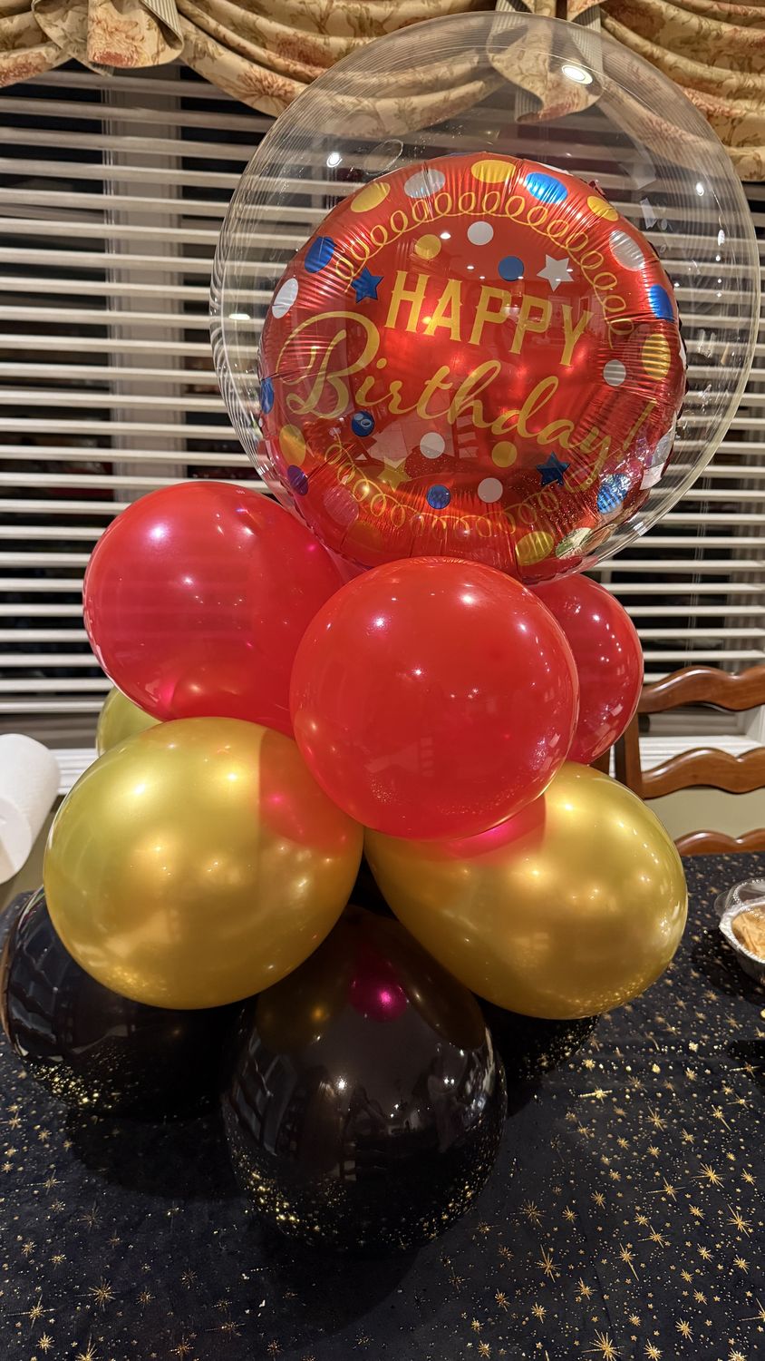 Happy Birthday bubble balloon centerpiece with red and gold balloons
