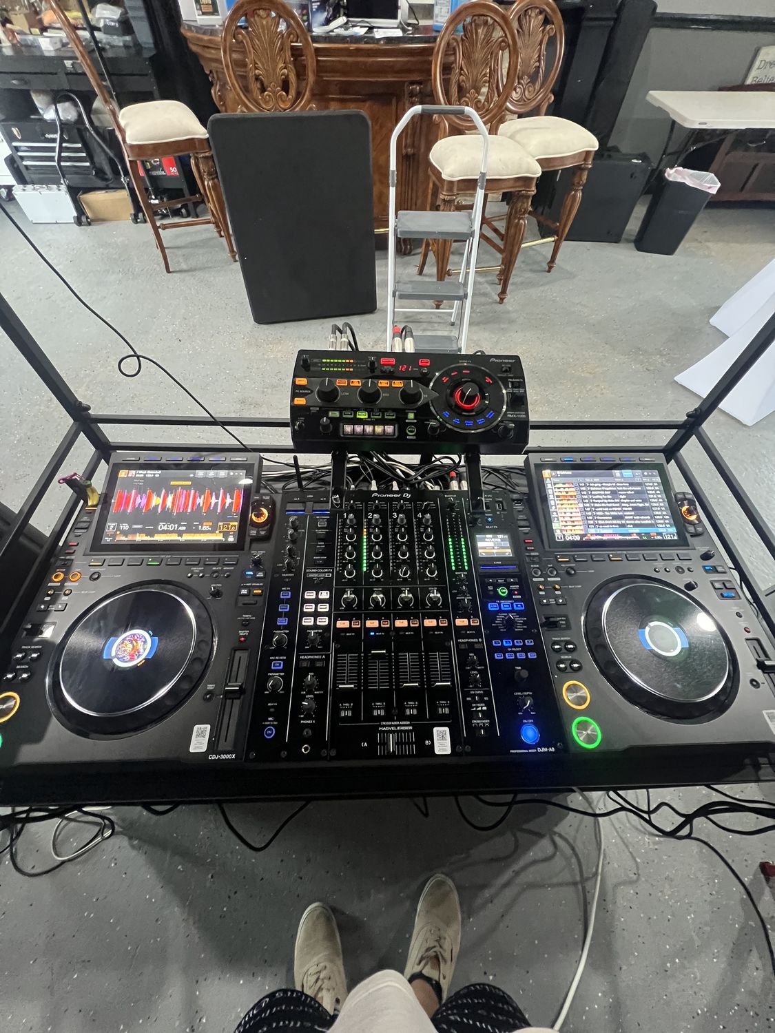 Pioneer CDJs and DJ mixer at an indoor venue