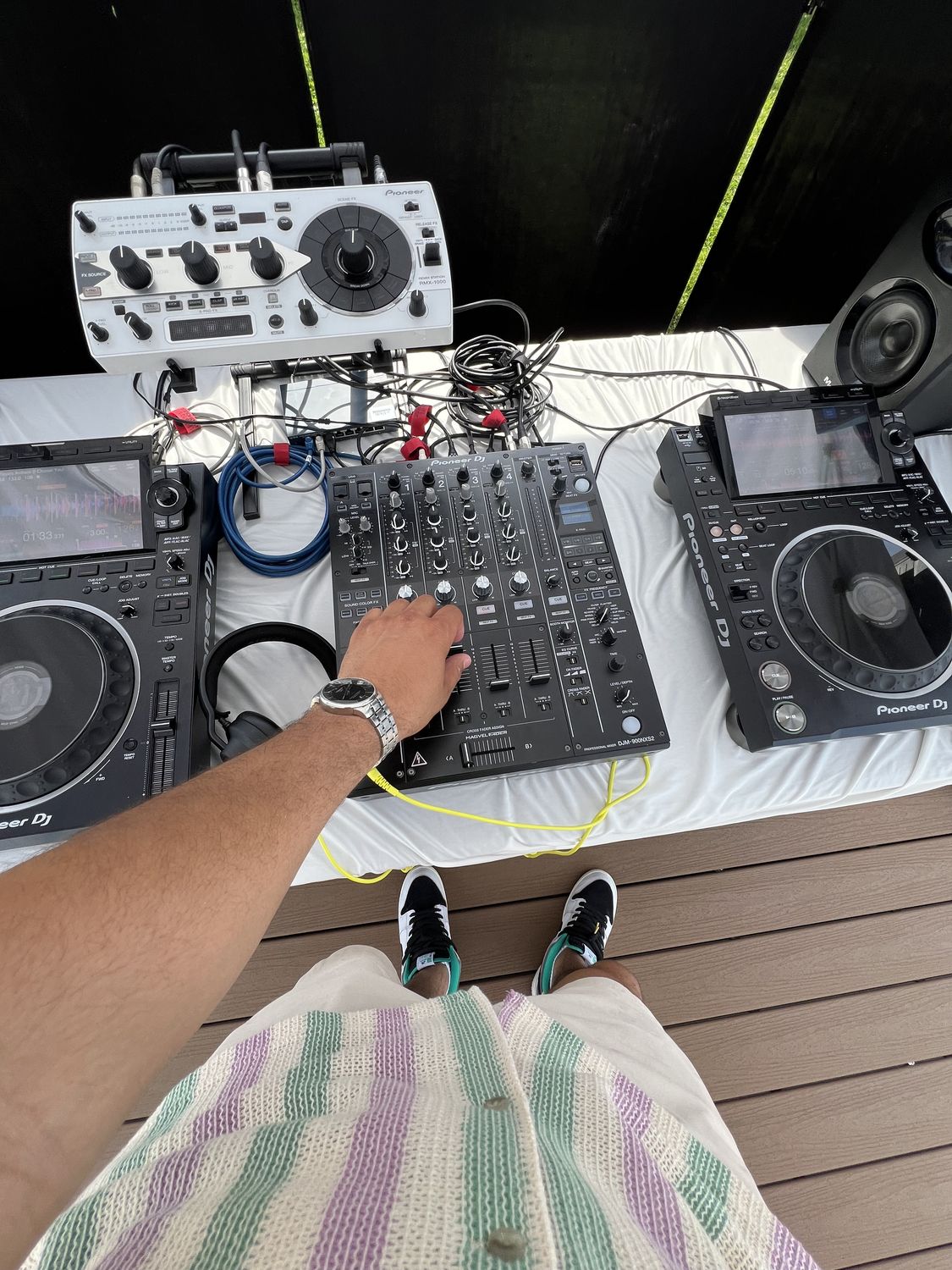 DJ view of Pioneer CDJs and mixer at a waterfront event