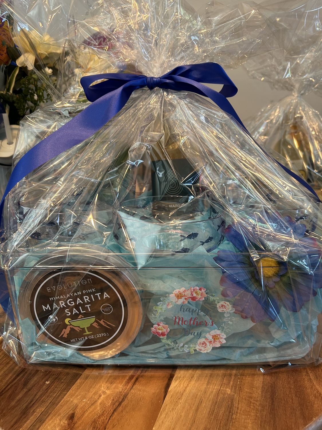 Wrapped gift basket with a blue ribbon