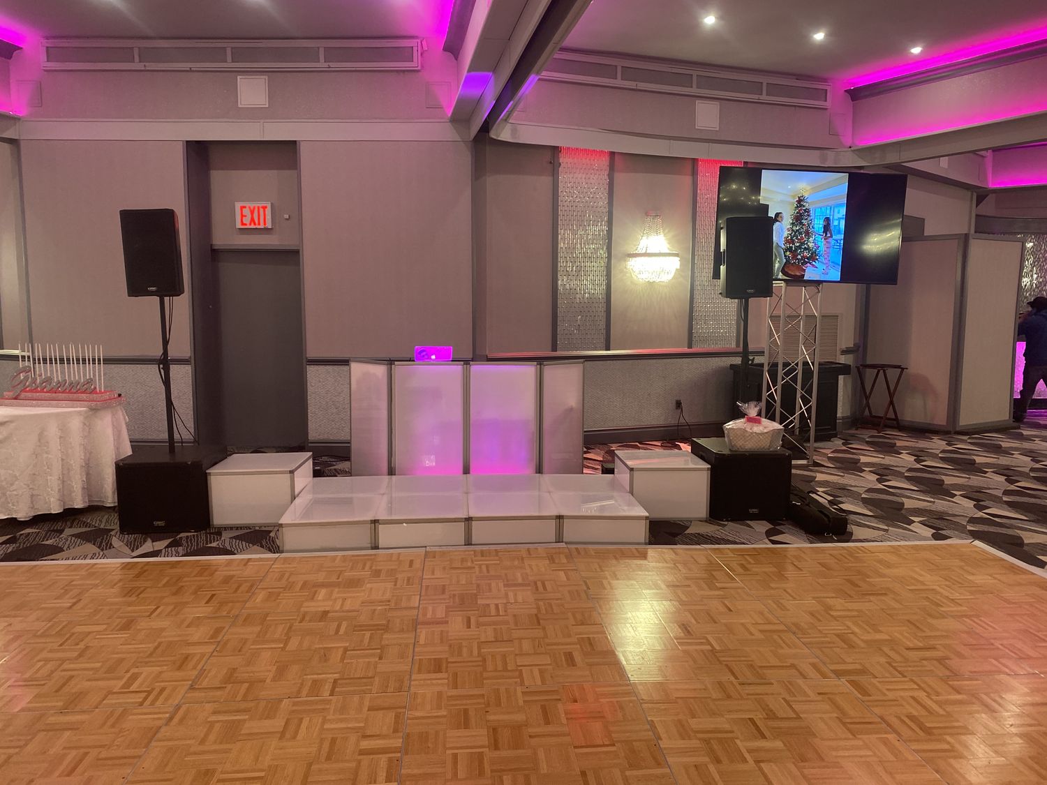Event room with pink uplighting, white lounge furniture and dance floor