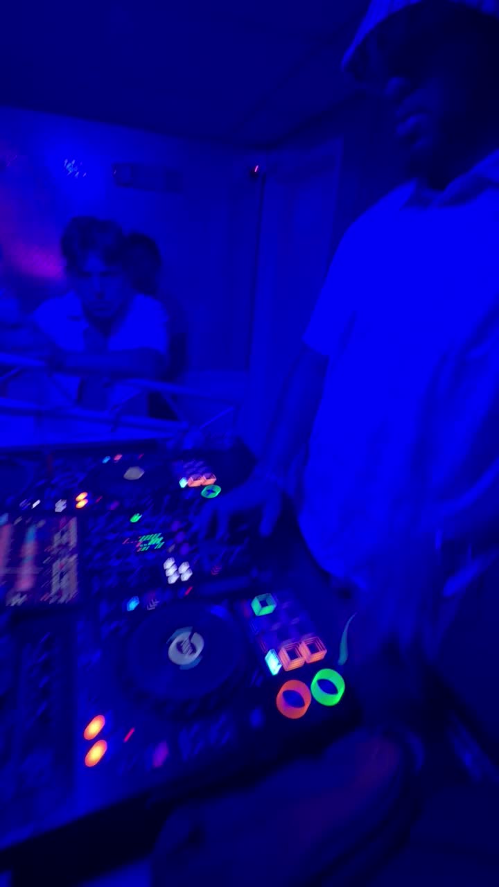 DJ behind the decks under blue light