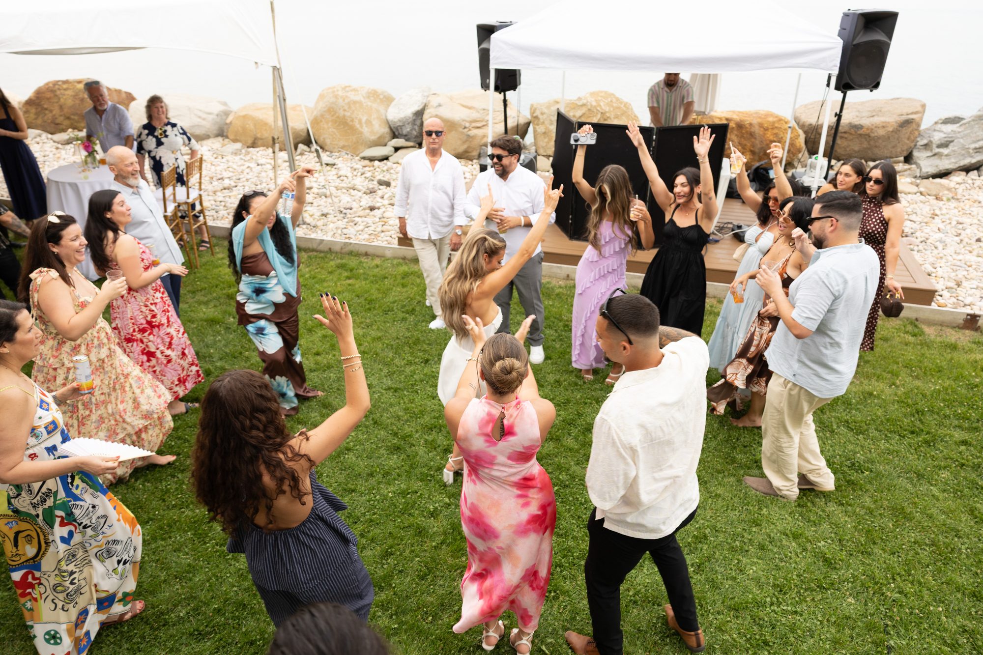 Guests dancing on the lawn at an oceanfront party